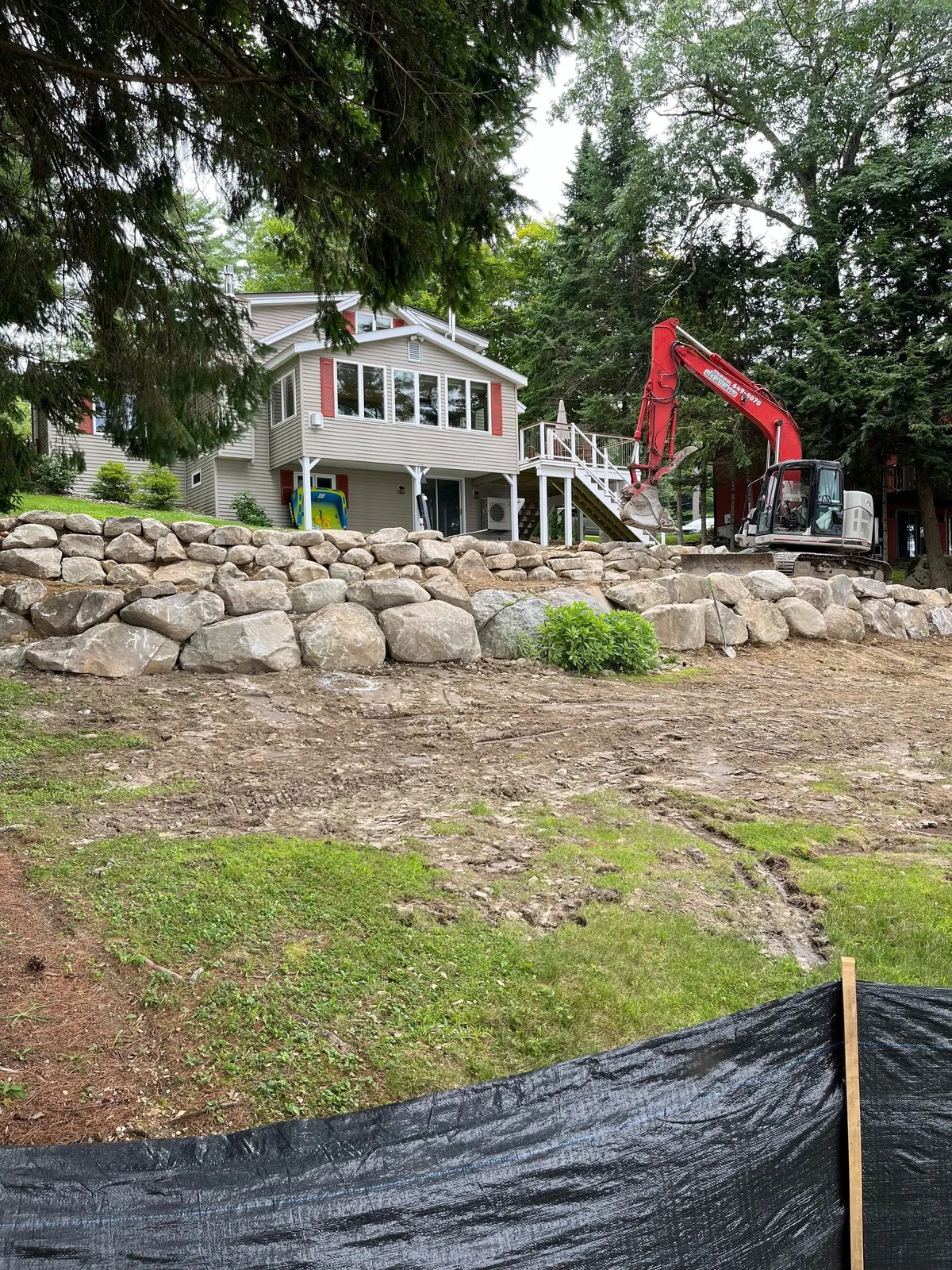 A stone retaining wall built into a sloped yard.