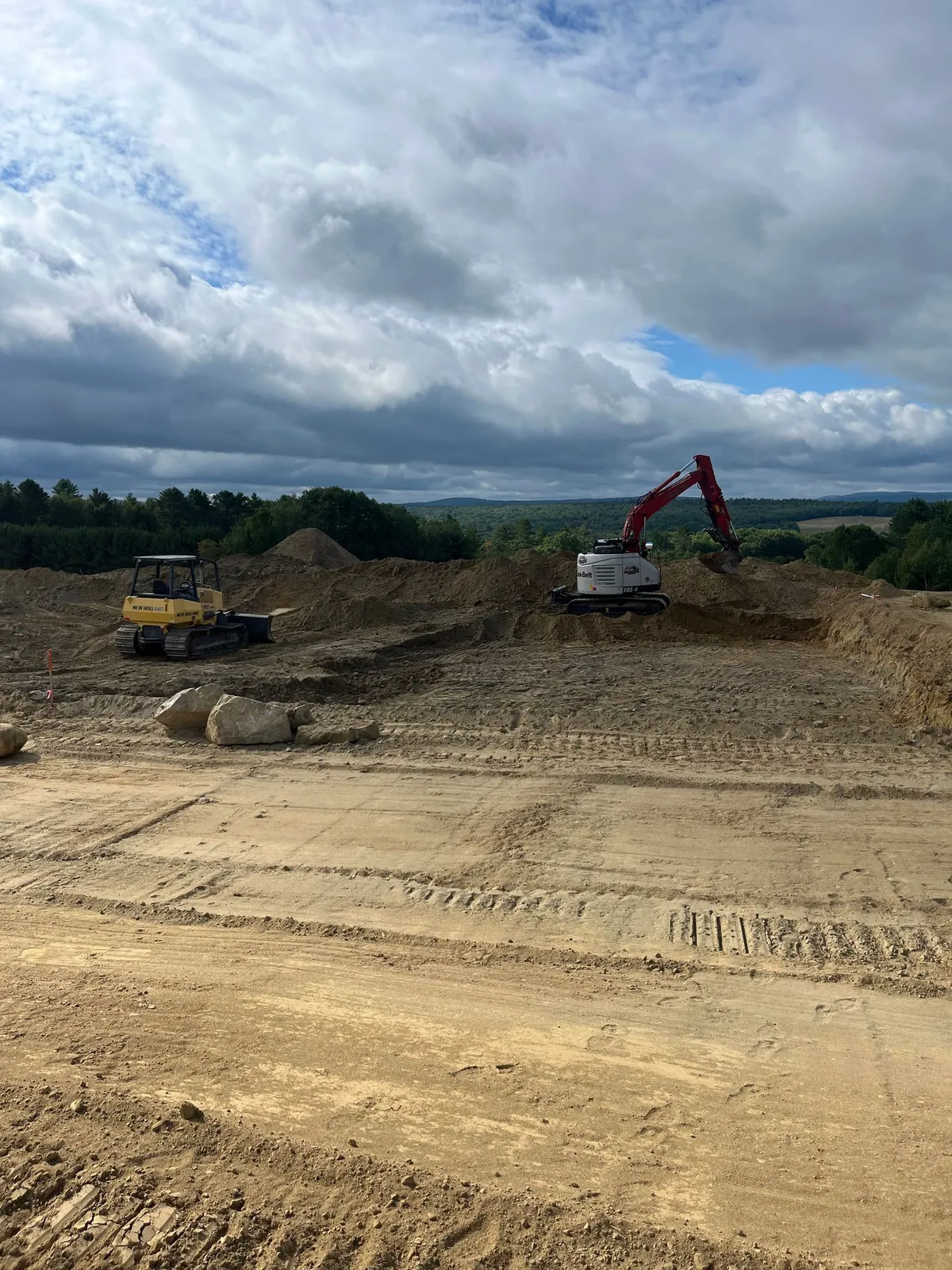 A newly excavated pond basin on a rural property.